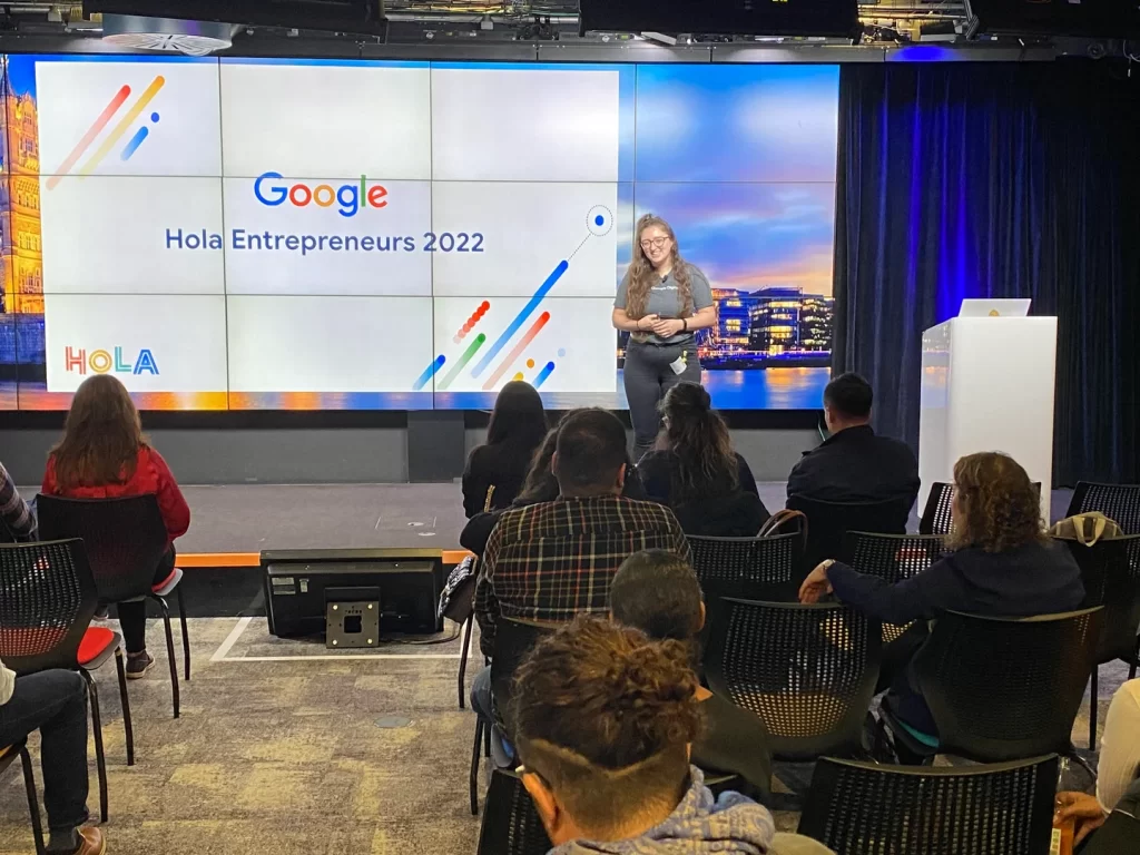 Kirstie Kavanagh speaking on stage at Google Hola Entrepreneurs 2022 in London, addressing an audience of founders and business leaders.