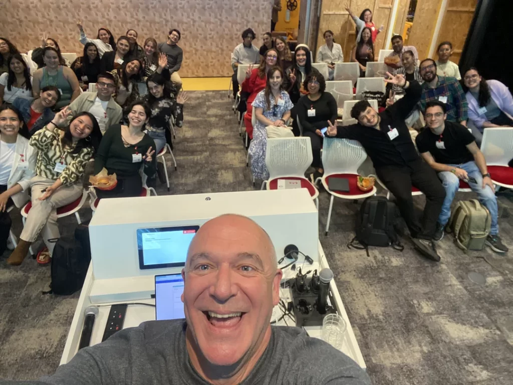 Glenn smiling with a group of LatinX entrepreneurs in London before delivering a digital marketing training session.